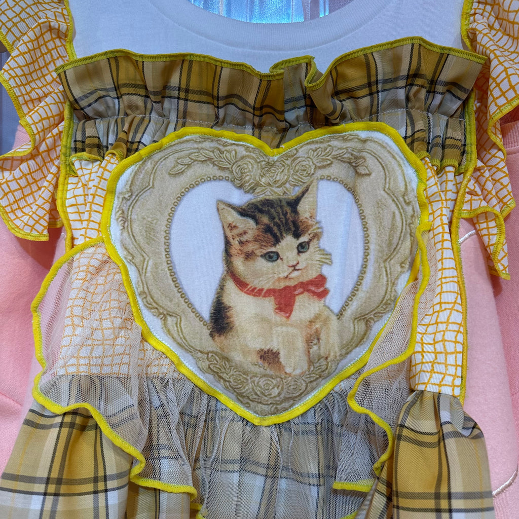 黄色のチェック柄とピンクの猫柄のスウェットシャツ